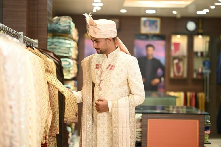 A man in traditional attire shopping in an Indian clothing store, showcasing cultural fashion.