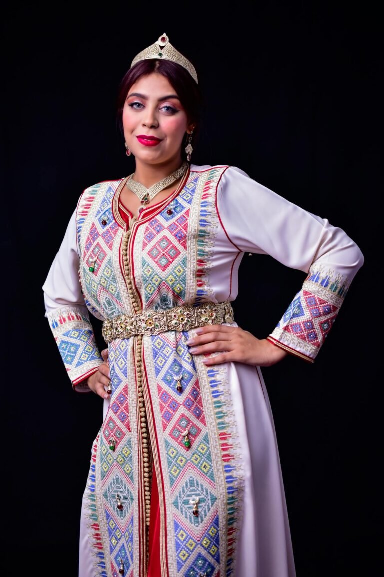 A woman in a traditional Moroccan kaftan with intricate patterns and jewelry, representing cultural heritage.